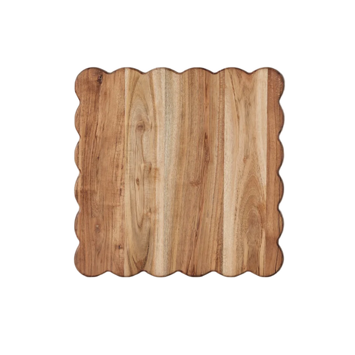 Wooden cutting board with scalloped edge on a white background