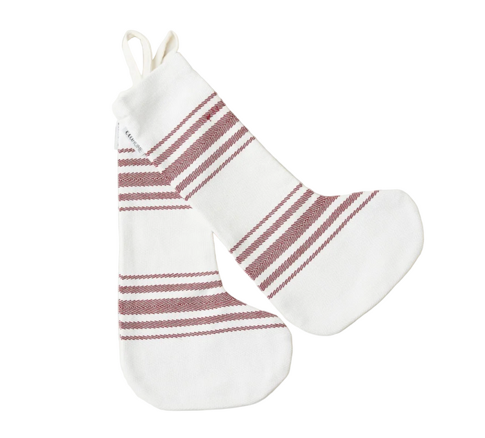 White Christmas stocking with red stripes on a white marble background