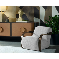Modern armchair with a decorative sideboard and abstract sculpture in the background