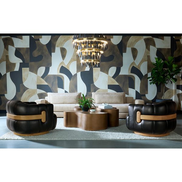 Modern living room with patterned wall, sofa, and decorative chairs.