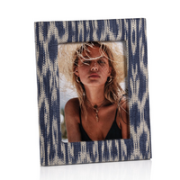 Blue and white patterned photo frame with a woman wearing a straw hat inside.