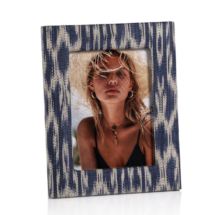 Blue and white patterned photo frame with a woman wearing a straw hat inside.