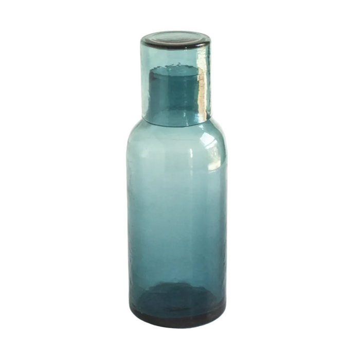 Aqua Blue glass carage with a cap on a white background