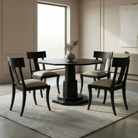 Dining room with a dark wooden table and chairs on a light gray rug.