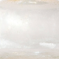 Close-up of a clear seeded glass table lamp base, showing its textured surface.