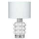 White Seltzer Mini Table Lamp with a textured glass base, clear glass stand, and off-white linen drum shade.