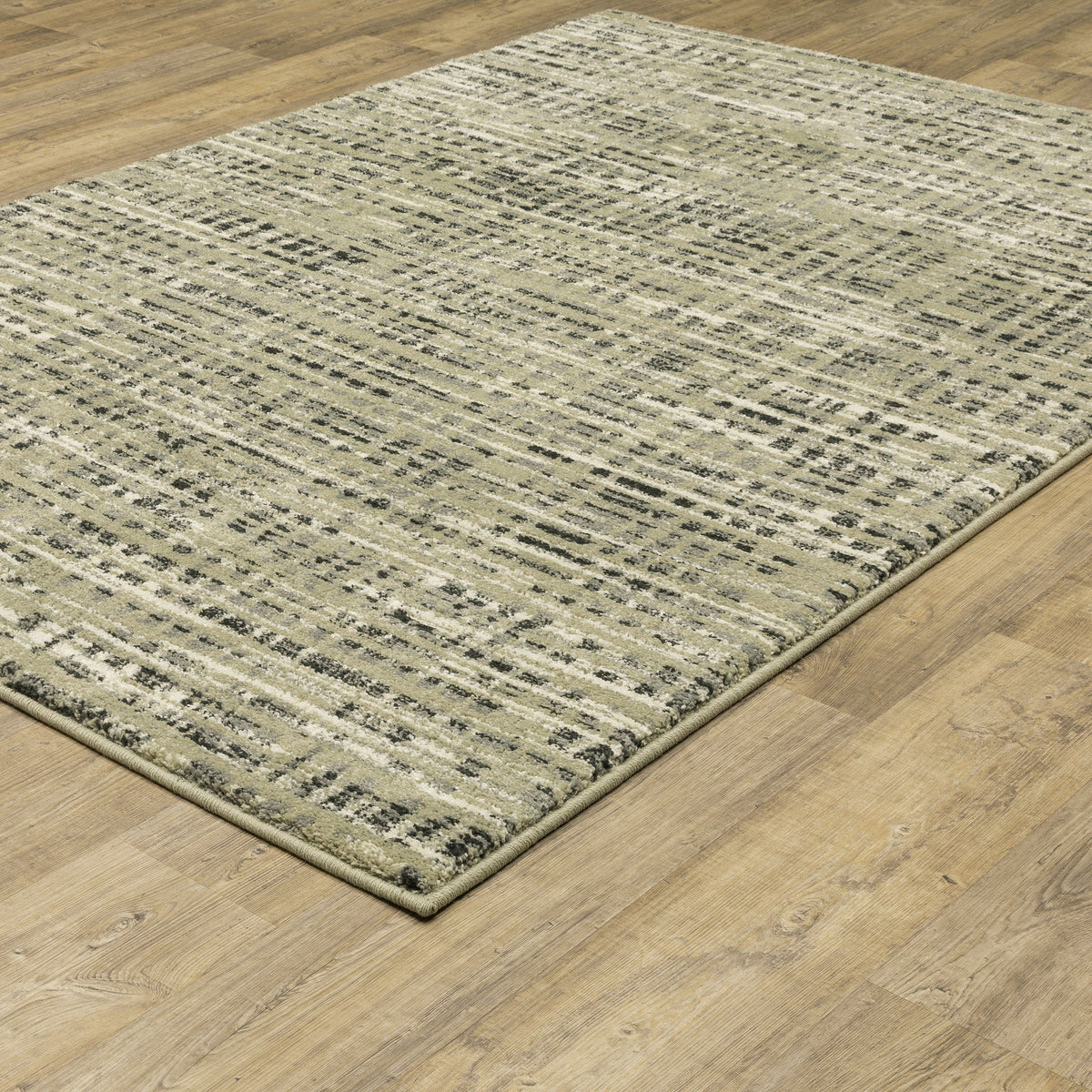Seneca Beige & Grey Casual Rug with abstract black, ivory, and green lines on a light wood floor.