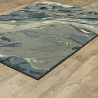 Seneca Blue & Green Contemporary Rug with abstract designs on a wooden floor.
