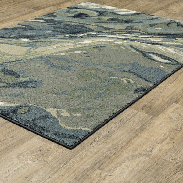 Seneca Blue & Green Contemporary Rug with abstract designs on a wooden floor.
