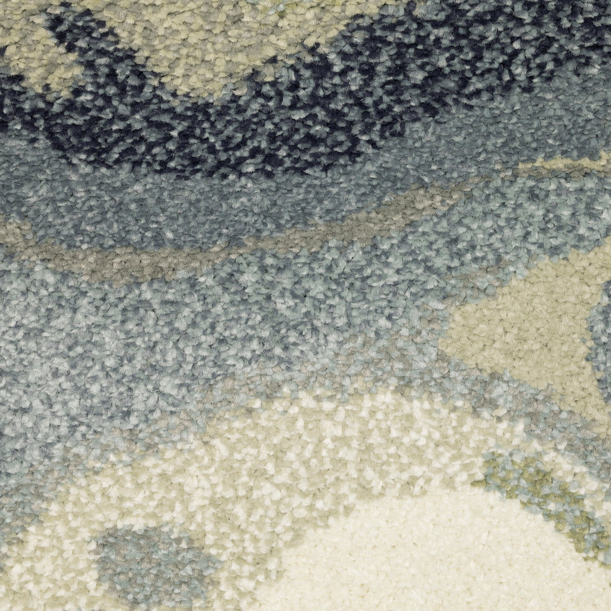 Close-up of Seneca Blue & Green Contemporary Rug, showing dense, super-soft polypropylene pile with abstract blue, green, and ivory patterns.