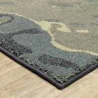Seneca Blue & Green Contemporary Rug with abstract design, dense polypropylene pile, and woven edge on wood floor.