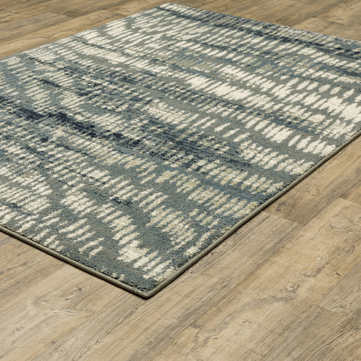 Seneca Grey & Beige Casual Rug with modern organic geometric design on a wood floor.