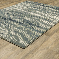 Seneca Grey & Beige Casual Rug with modern organic geometric design on a wood floor.