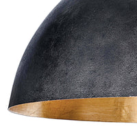 Large black dome pendant light with a textured exterior and a gold-leafed interior rim.