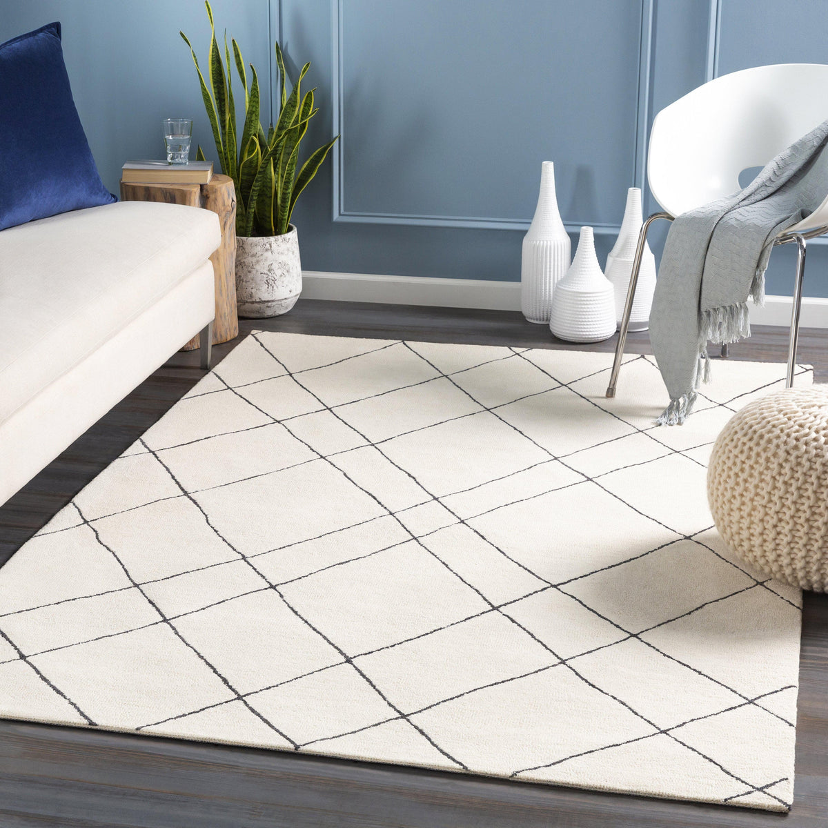 Cream and black hand-tufted wool rug with a globally inspired diamond pattern.