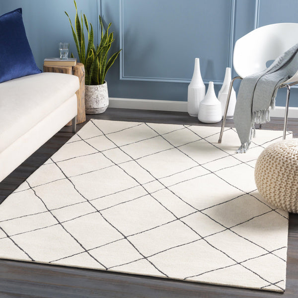 Cream and black hand-tufted wool rug with a globally inspired diamond pattern.