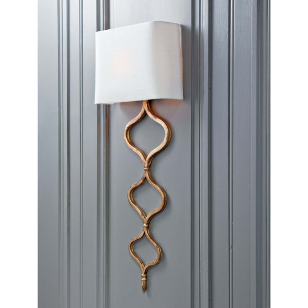 Elegant Sinuous Sconce Gold Leaf wall light with a twisting metal pattern and natural linen shade.