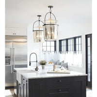 Two Emerson Bell Jar Pendants with antique mercury glass and oil rubbed bronze hardware illuminate a kitchen island.