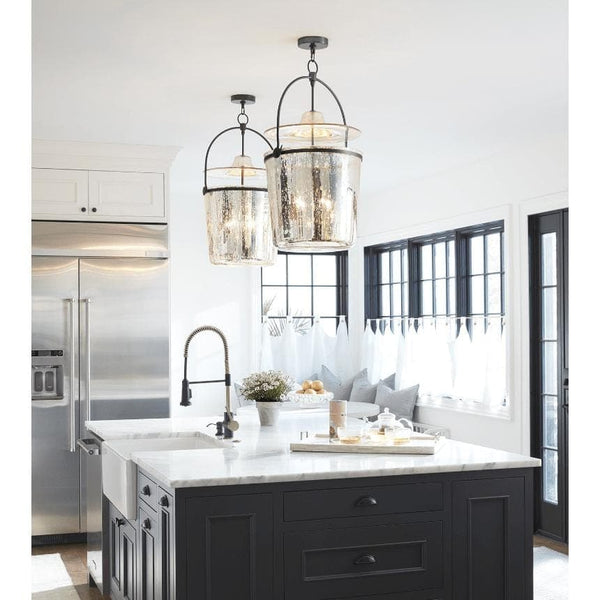 Two Emerson Bell Jar Pendants with antique mercury glass and oil rubbed bronze hardware illuminate a kitchen island.