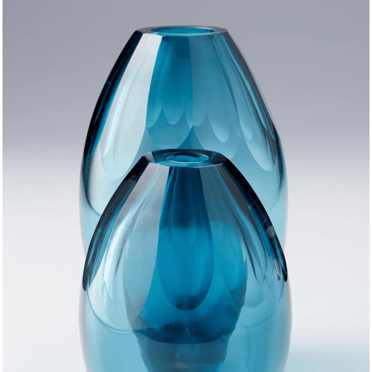 Small ocean blue handcrafted glass vase with elegant design, ideal for luxury home décor.