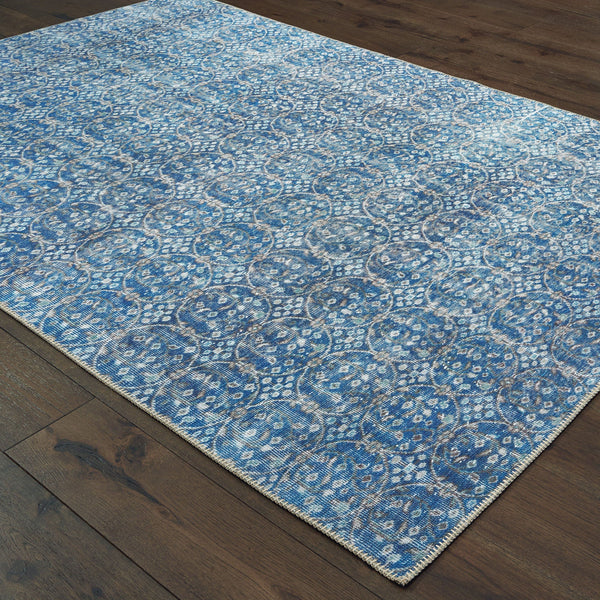 Sofia Blue & Brown Casual Rug with distressed traditional pattern on dark wood floor.