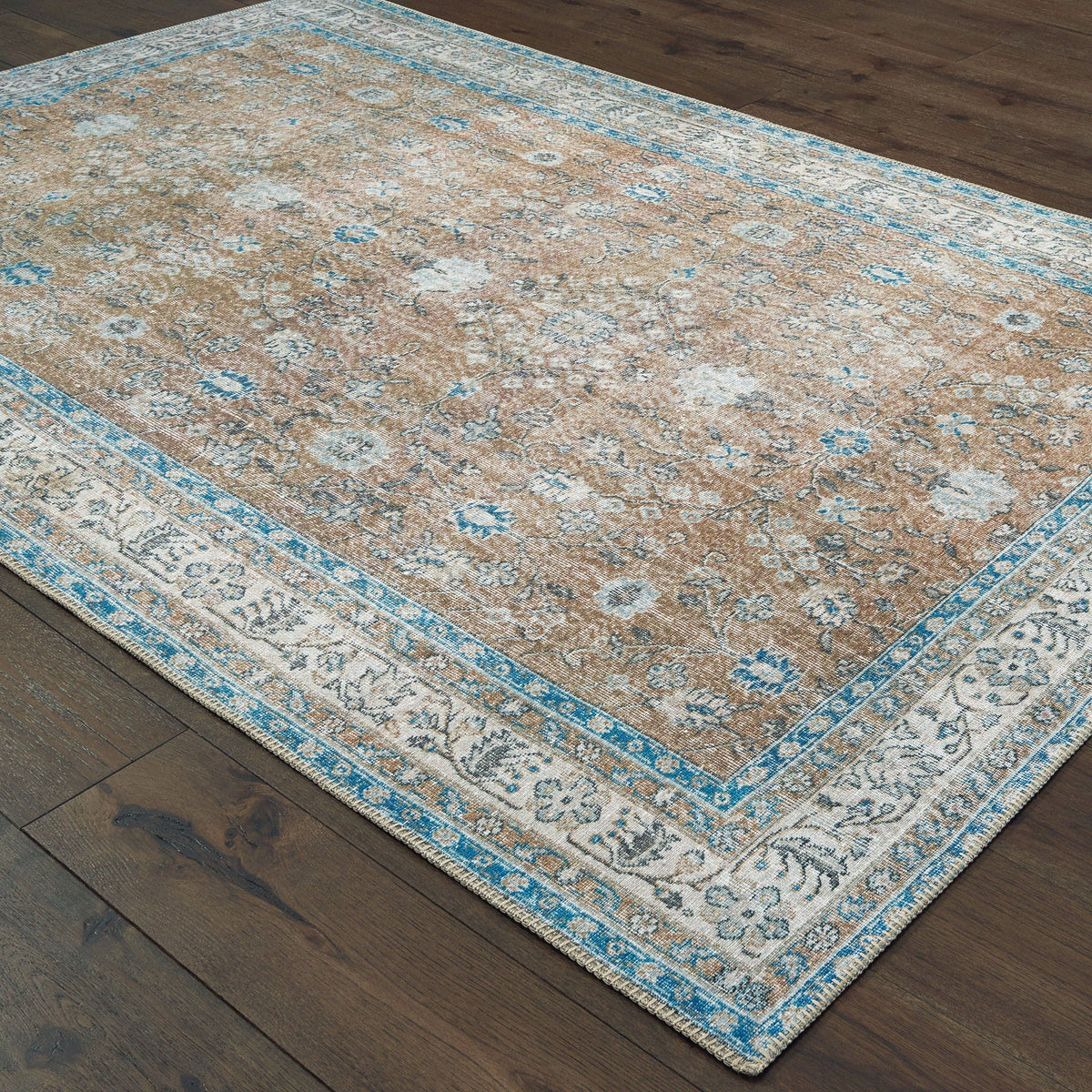Sofia Gold & Blue Traditional Rug with antique-inspired floral design on dark wood floor.