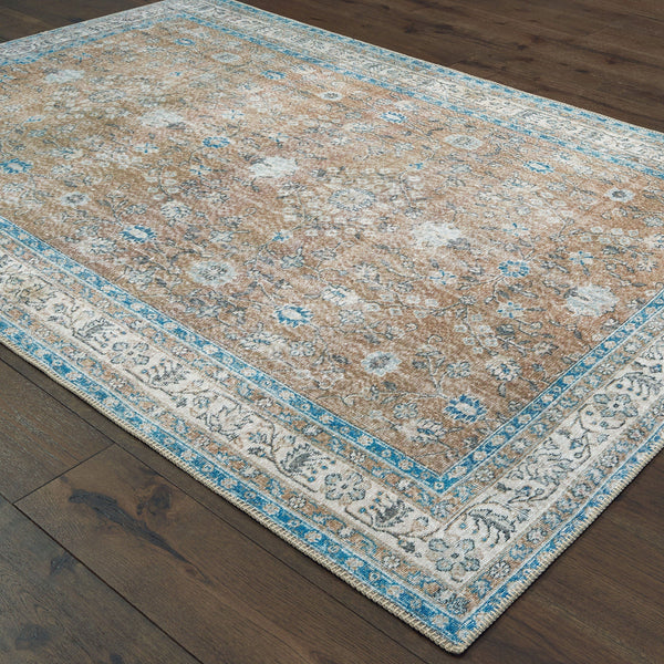 Sofia Gold & Blue Traditional Rug with antique-inspired floral design on dark wood floor.