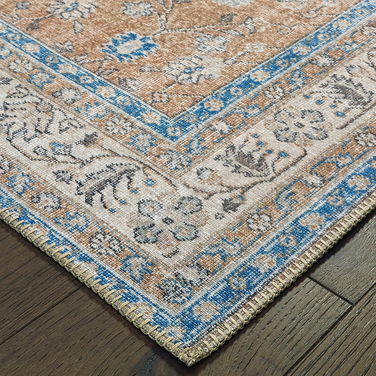 Sofia Gold & Blue Traditional Rug with antique-inspired floral design, intricate blanket stitch, on wood floor.
