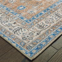 Sofia Gold & Blue Traditional Rug with antique-inspired floral design, intricate blanket stitch, on wood floor.