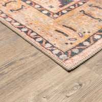 Sofia Gold & Charcoal traditional rug with distressed pattern on a wood floor.
