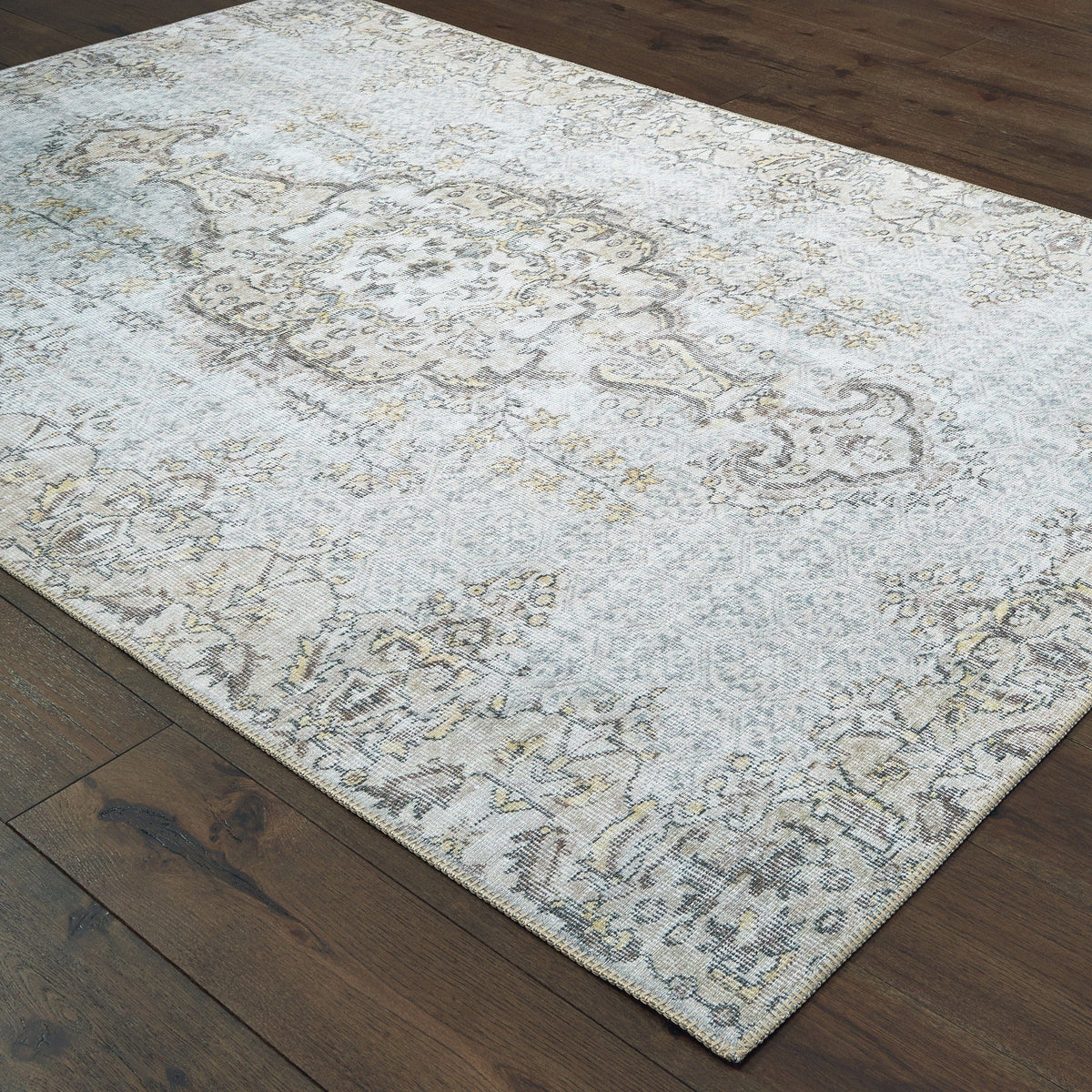 Sofia Grey & Gold Traditional Rug with distressed pattern on dark wood floor.