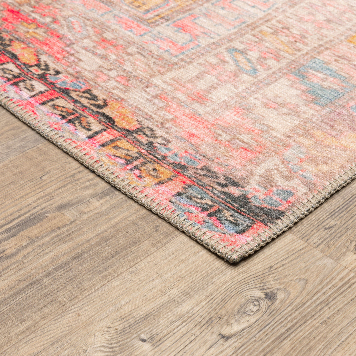 Sofia Pink Distressed Traditional Rug with vintage-inspired design, intricate blanket stitch, and polyester chenille texture.