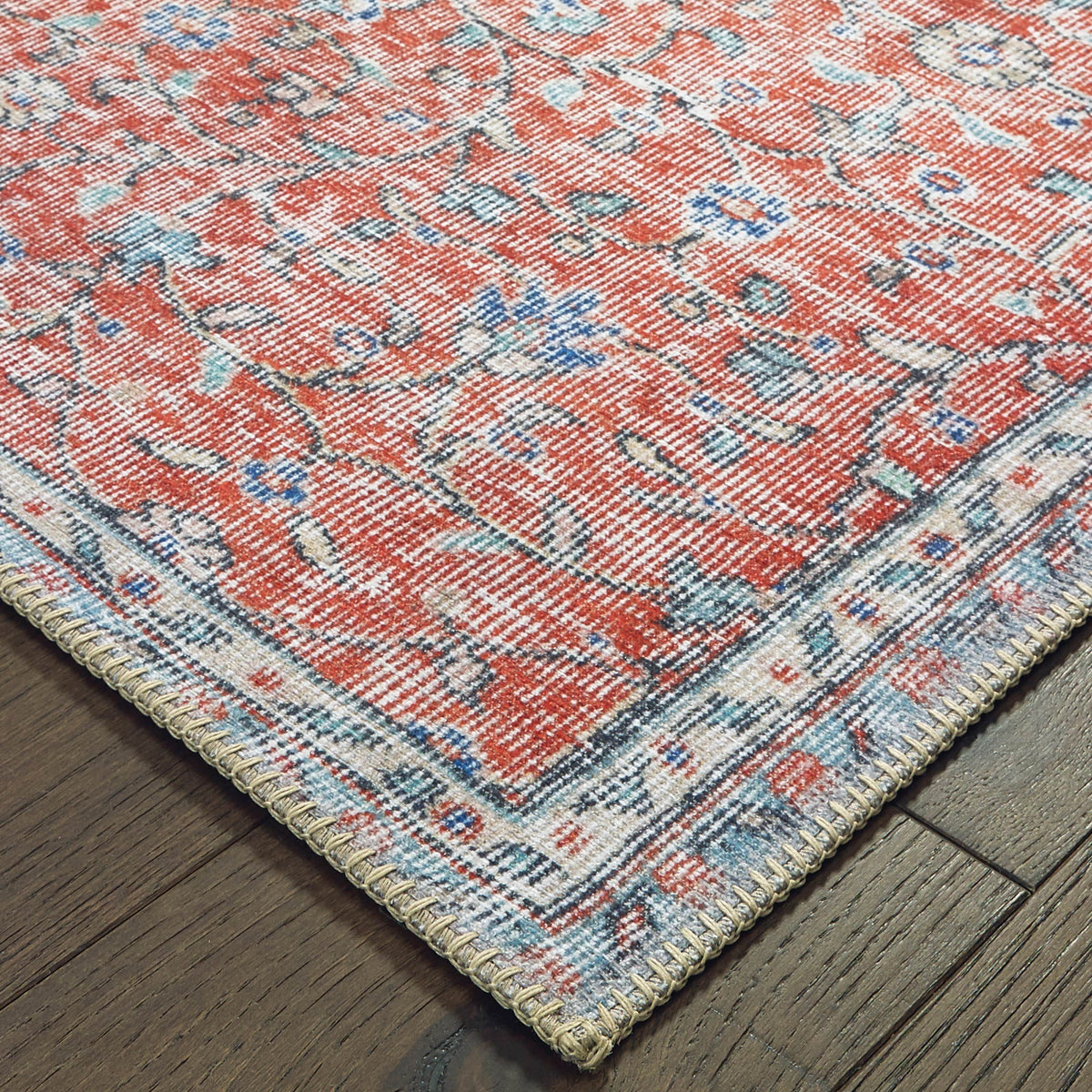 Sofia Red & Blue Casual Rug with distressed traditional pattern, machine-woven polyester chenille, on wood floor.