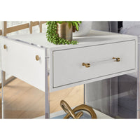 Sonia Pearl Shagreen & Lucite 1-Drawer Nightstand with gold hardware and a plant on top.
