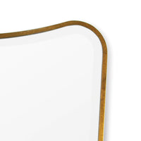 Sonnet dressing room mirror with a gold-leafed, curved frame and beveled glass.