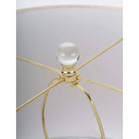 Close-up of a Stowe crystal table lamp with a polished brass spider and clear crystal finial.