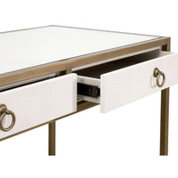 Pearl white faux shagreen desk with glass top, brushed gold frame, and two open drawers with ring pulls.