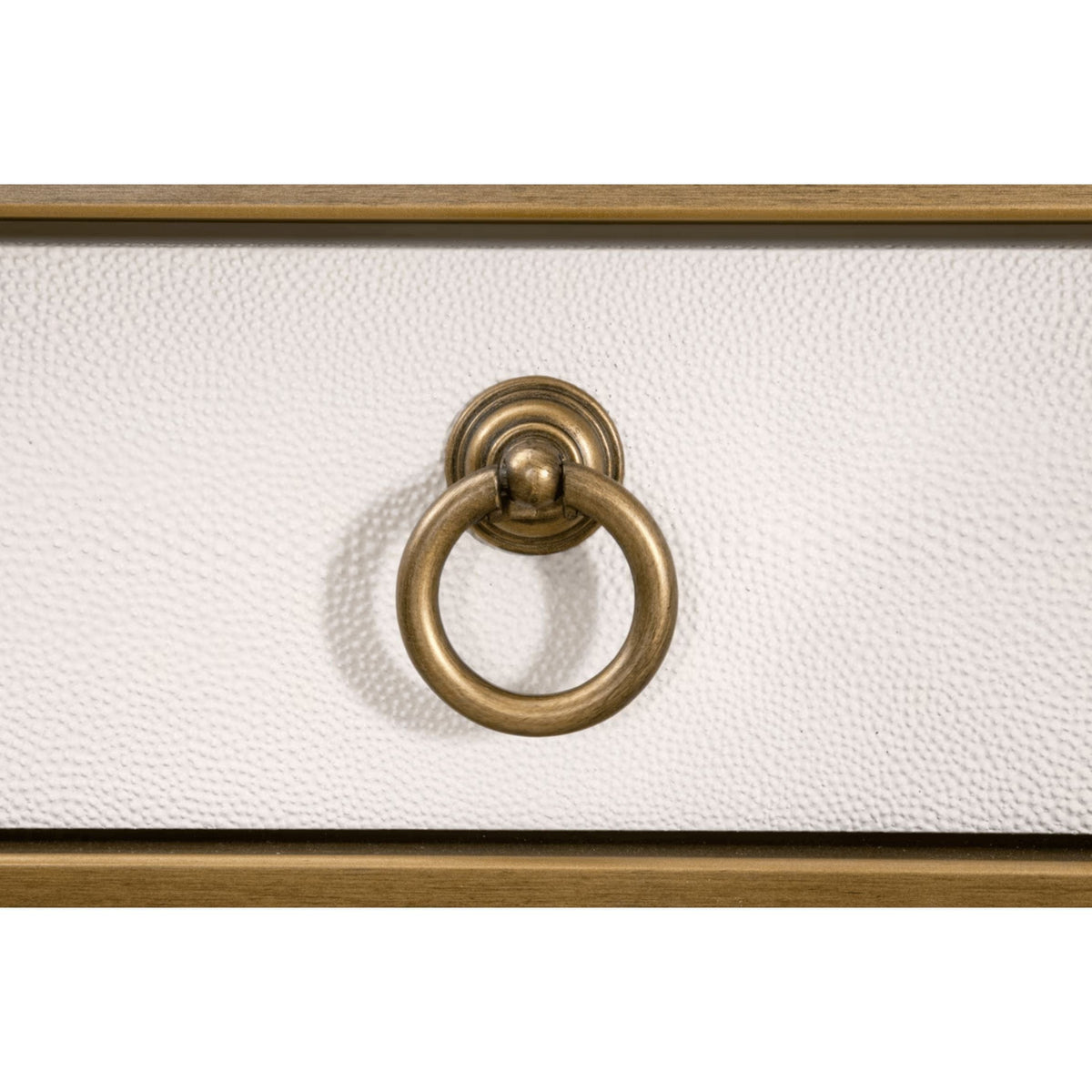 Close-up of pearl white faux shagreen desk drawer with brushed gold ring pull.
