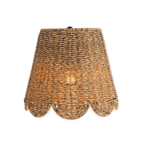 Woven rattan outdoor sconce with a scalloped bottom edge, emitting a warm glow.