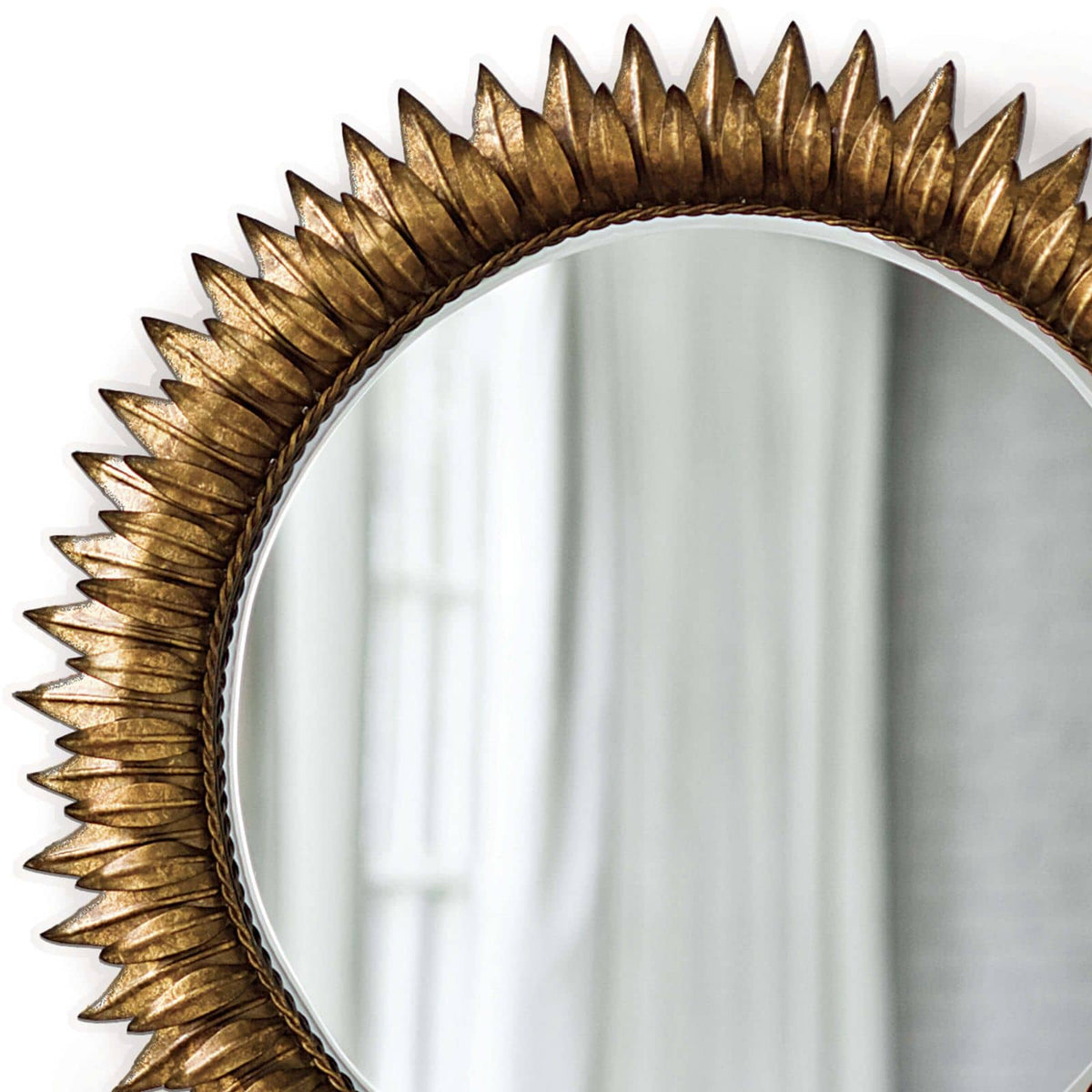 Antique gold leaf sunburst mirror with a beveled round glass.