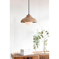 Natural wood grain pendant light with a white-washed finish and milk glass globe, hanging above books and greenery.