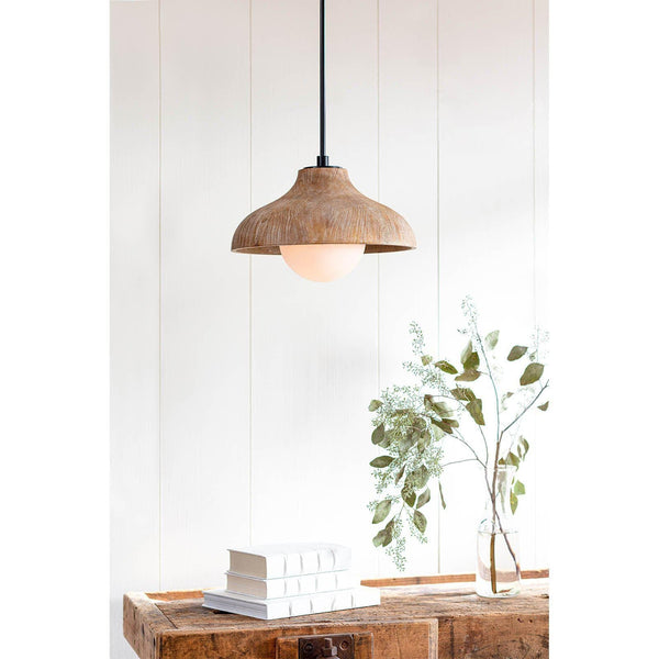 Natural wood grain pendant light with a white-washed finish and milk glass globe, hanging above books and greenery.