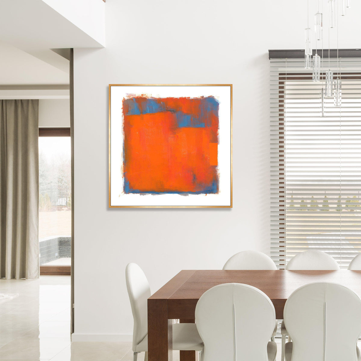 Abstract giclee canvas painting with orange and blue color blocks in a gold frame, displayed in a modern dining room.
