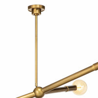 Modern Talon Chandelier in natural brass with adjustable arms and exposed G-type bulbs.