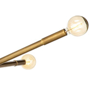 Close-up of Talon Chandelier in natural brass with two angled arms and exposed G-type bulbs.