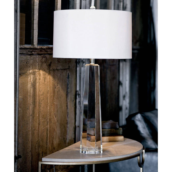 Tapered hex crystal table lamp with a clear base, polished nickel accents, and a white linen shade.