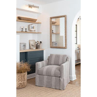 Polished nickel Tate Picture Light illuminates a wall niche with wooden shelves and decor.