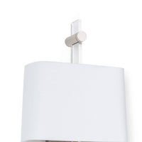 Taurus sconce with an acrylic body, polished nickel accents, and a white linen shade.