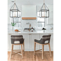 Two Tootsie Gray Rope Counter Stools with woven backs, gray teak legs, and white cushions in a modern kitchen.