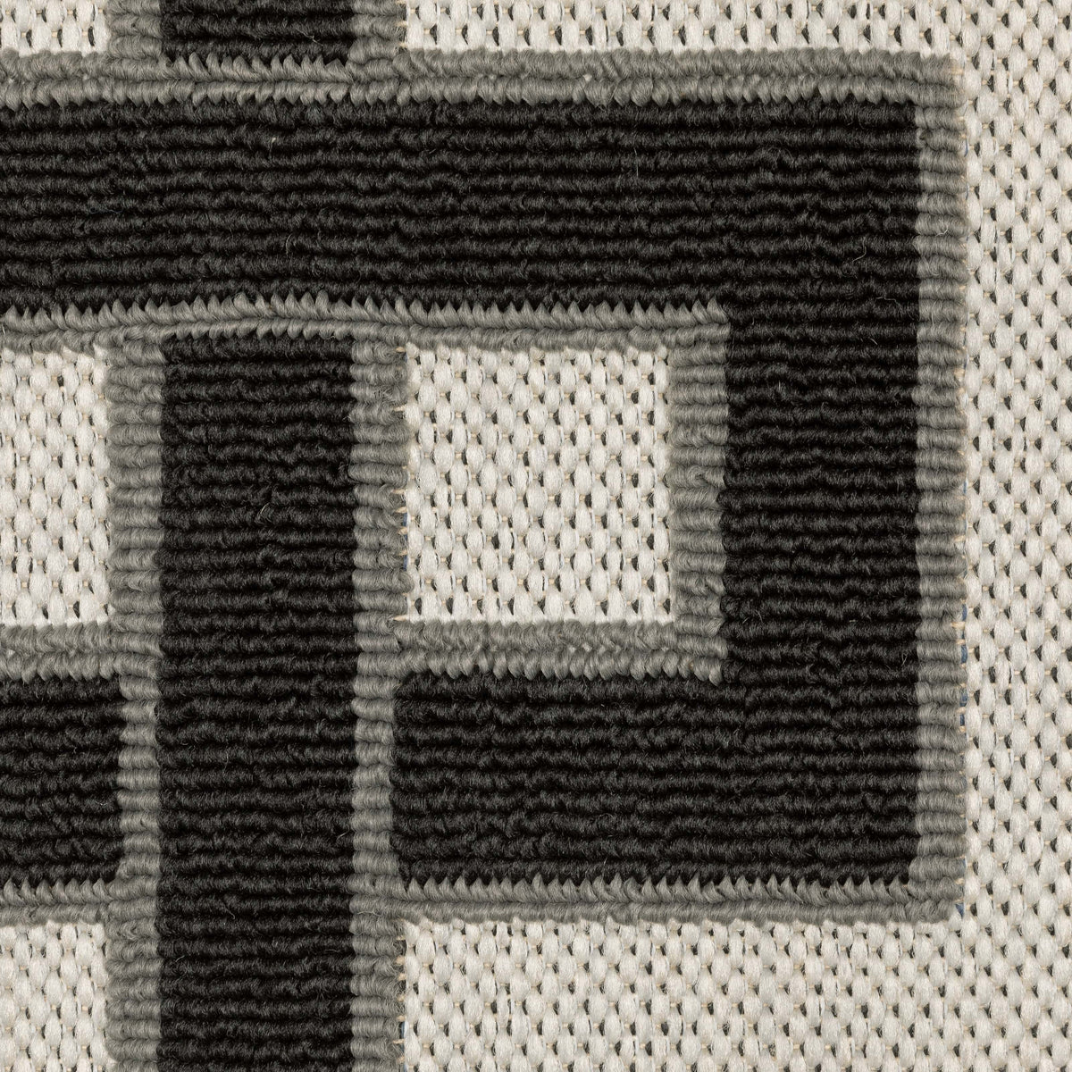 Close-up of Torrey Beige & Black Outdoor Rug, showing tri-colored loop pile pattern on a platinum flatwoven base.